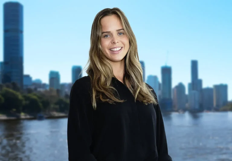 Mikaela smiling with Brisbane city in the background