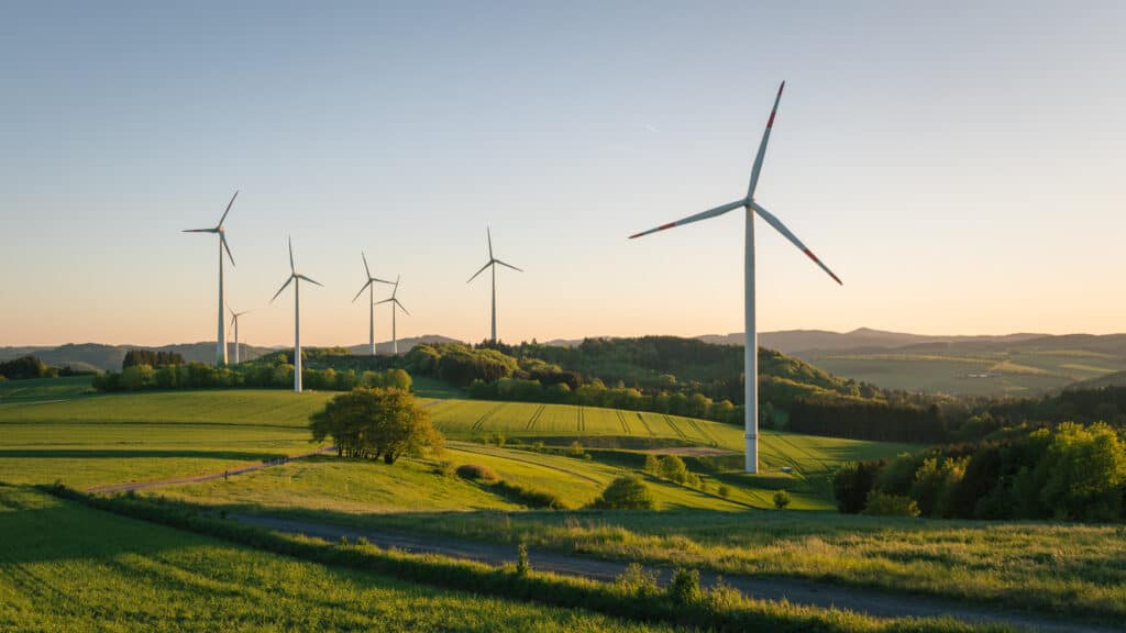 renewable energy wind turbines in green fields. 